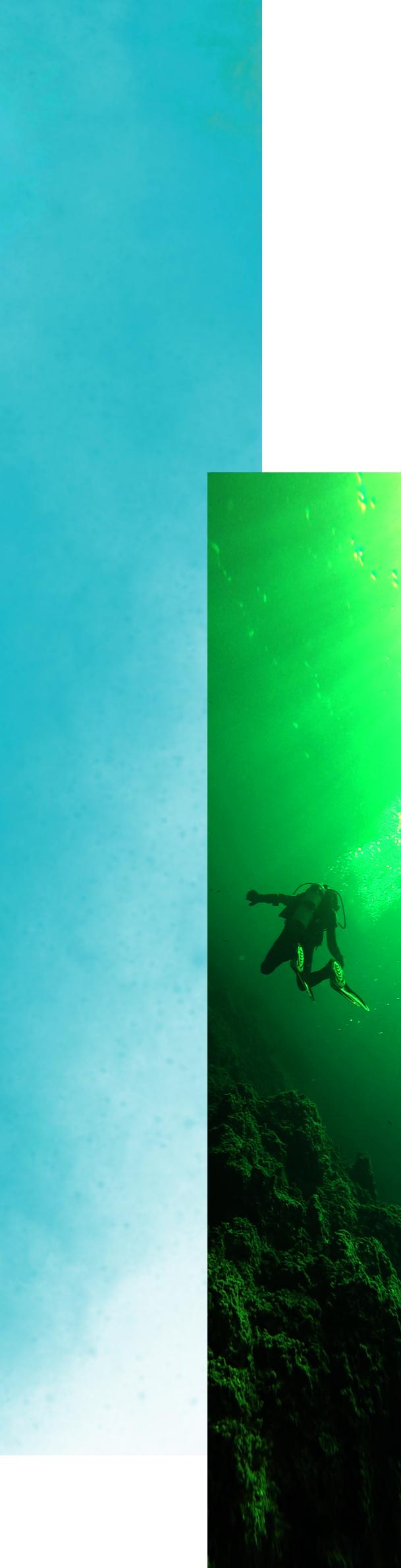 Scuba diver close to underwater rocks