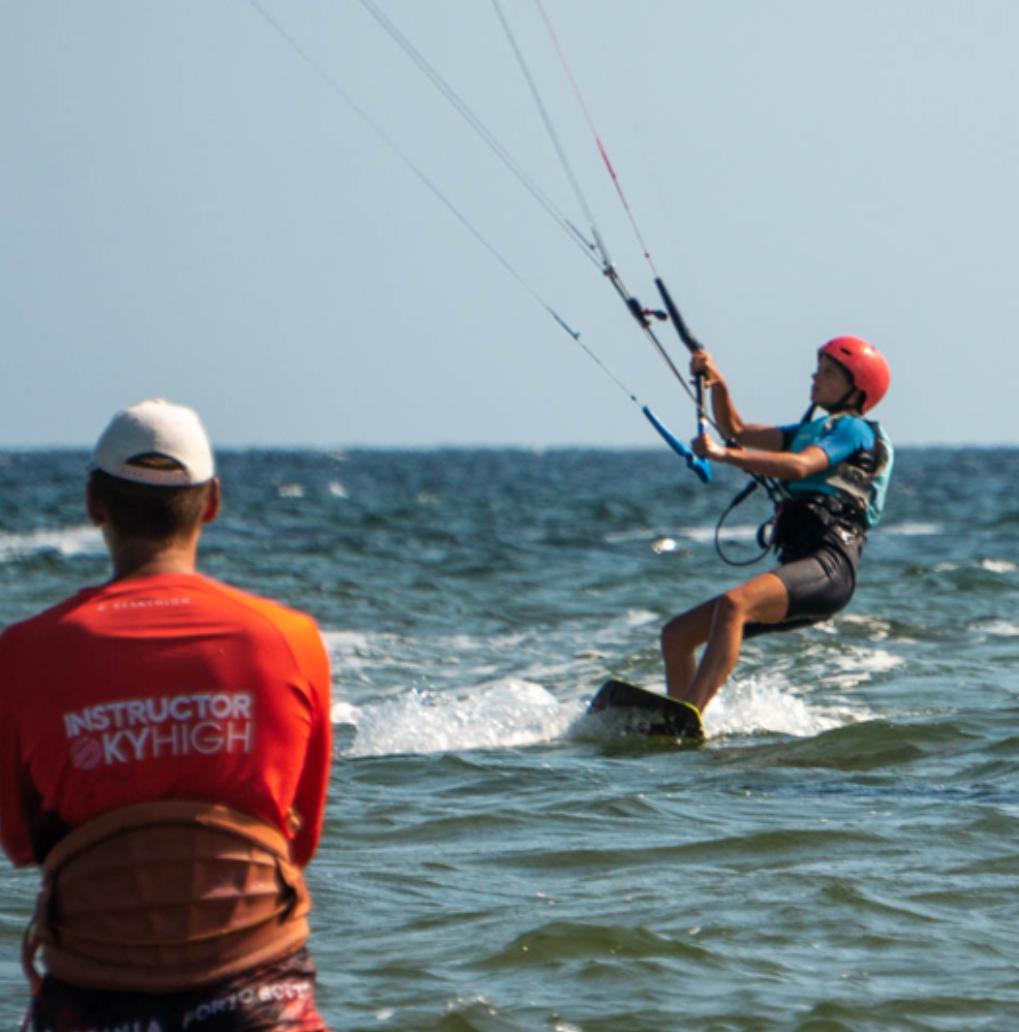 Kitesurfer with instructor at the first plan