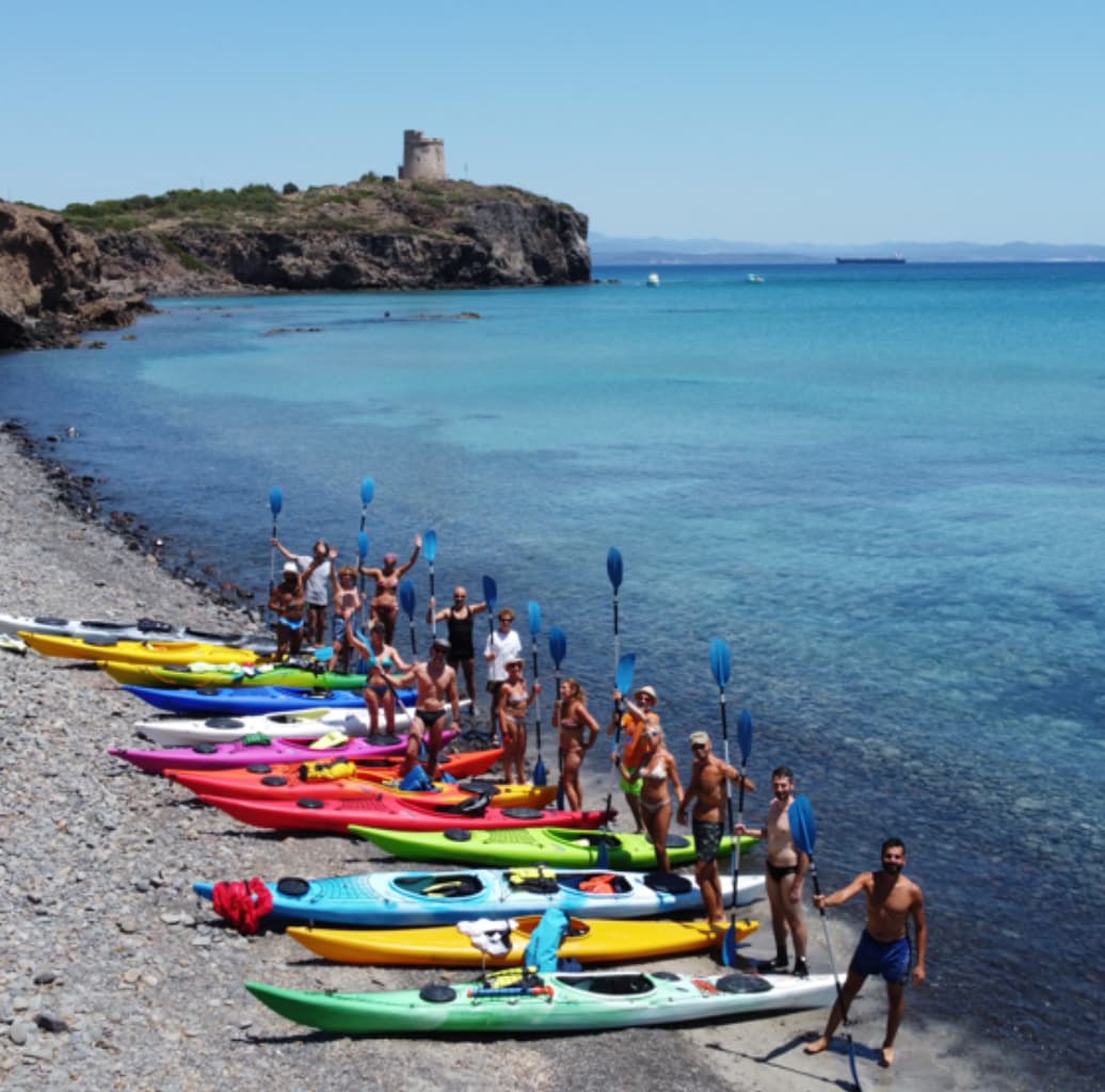 Bunch of people with puddles in hands and canoes on shore